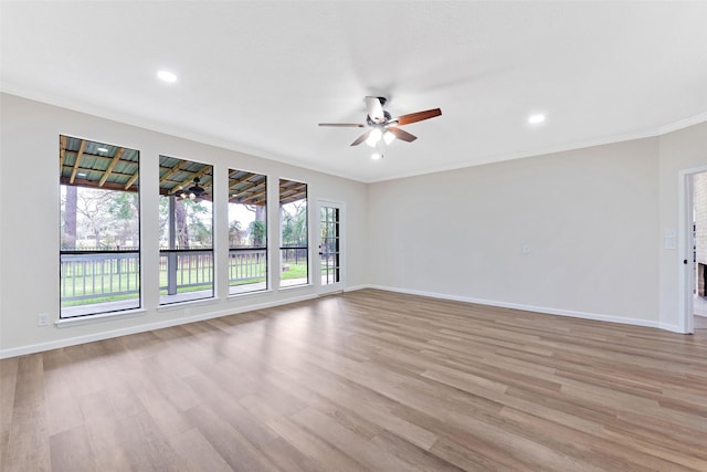 empty room with ornamental molding, recessed lighting, light wood finished floors, baseboards, and ceiling fan