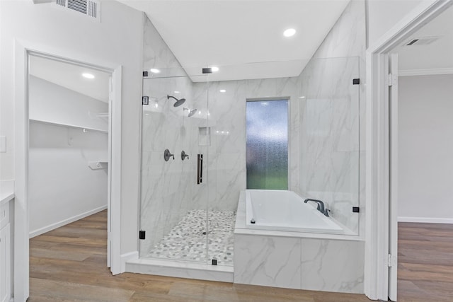 full bathroom featuring a marble finish shower, visible vents, a garden tub, and wood finished floors