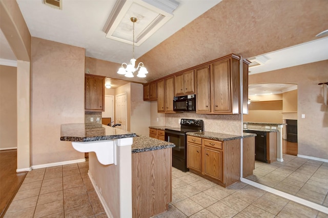 kitchen with dark stone countertops, tasteful backsplash, black appliances, and a peninsula