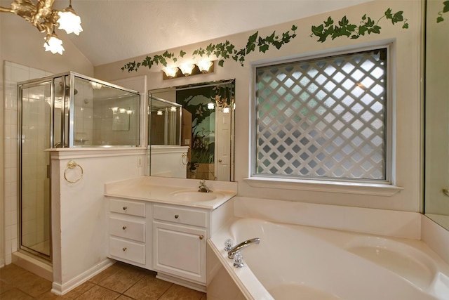 bathroom featuring vanity, a shower stall, vaulted ceiling, tile patterned floors, and a bath