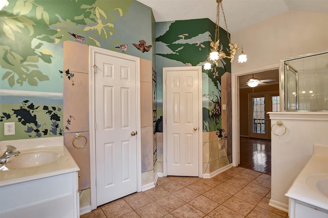 full bath with lofted ceiling, vanity, and tile patterned flooring