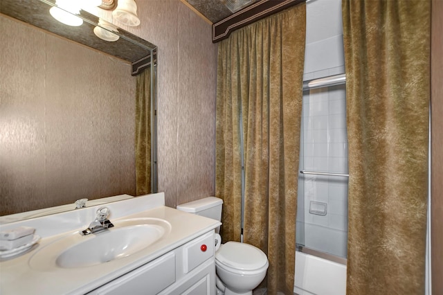 full bathroom featuring combined bath / shower with glass door, toilet, and vanity