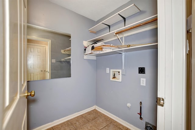 laundry room featuring gas dryer hookup, tile patterned flooring, hookup for an electric dryer, hookup for a washing machine, and laundry area