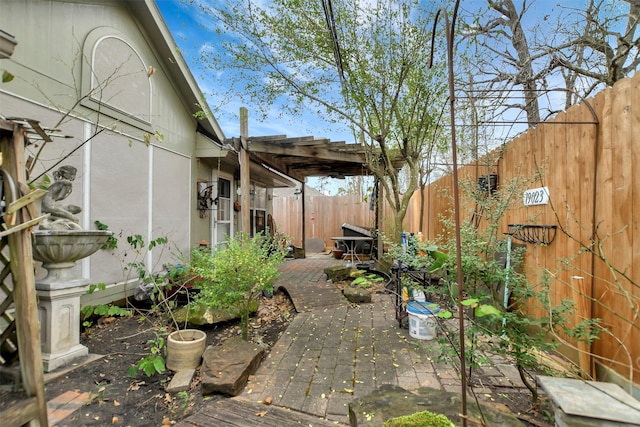 exterior space with a fenced backyard and a pergola