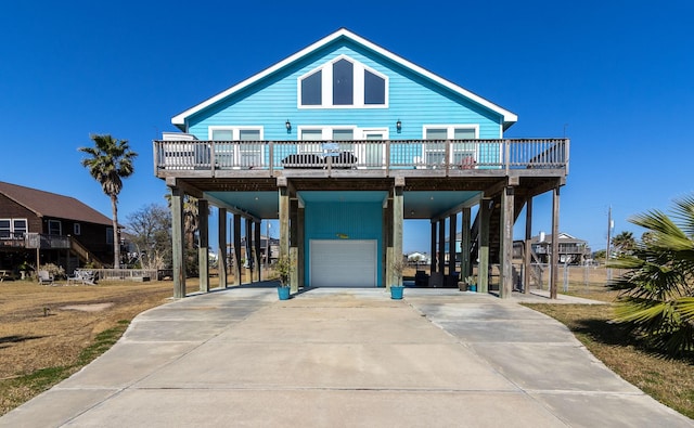 beach home featuring a carport, stairway, and concrete driveway