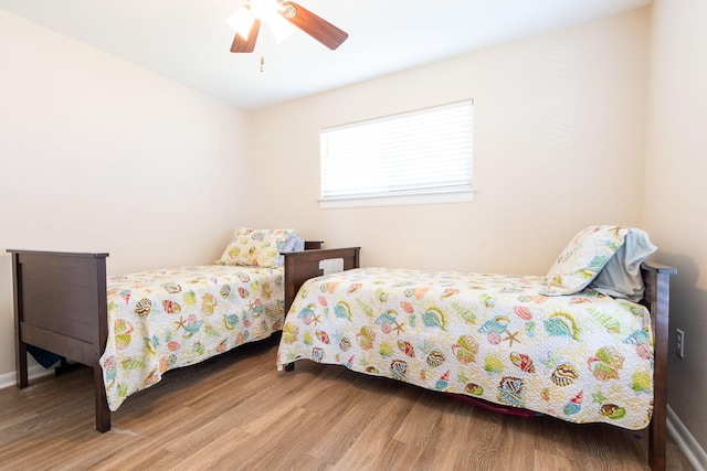 bedroom with a ceiling fan and wood finished floors