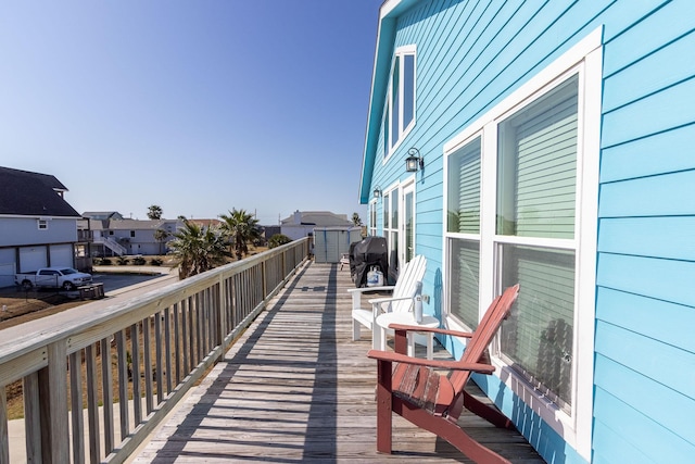 deck featuring a residential view and grilling area