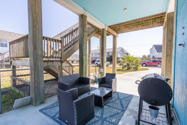 view of patio / terrace with an outdoor living space, stairway, a grill, and fence