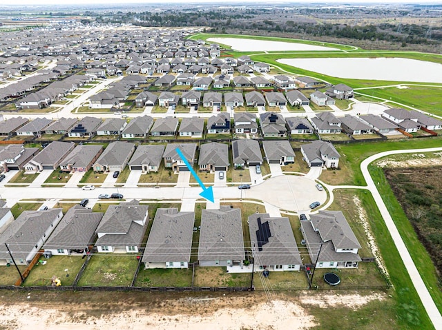 drone / aerial view with a residential view and a water view