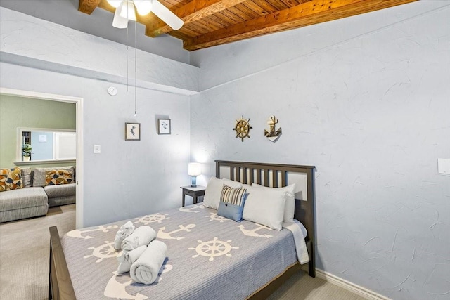 carpeted bedroom with beam ceiling, wooden ceiling, baseboards, and ceiling fan