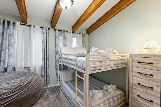 bedroom with beam ceiling and carpet