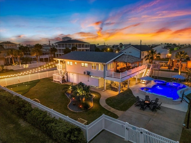 rear view of property with a residential view, a patio, a fenced backyard, and a gate