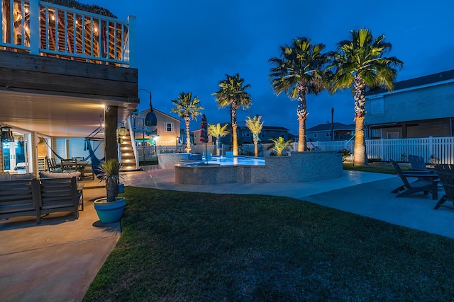 yard at twilight with a patio, a fenced backyard, and outdoor lounge area