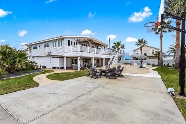 rear view of property featuring fence, a lawn, and a patio area