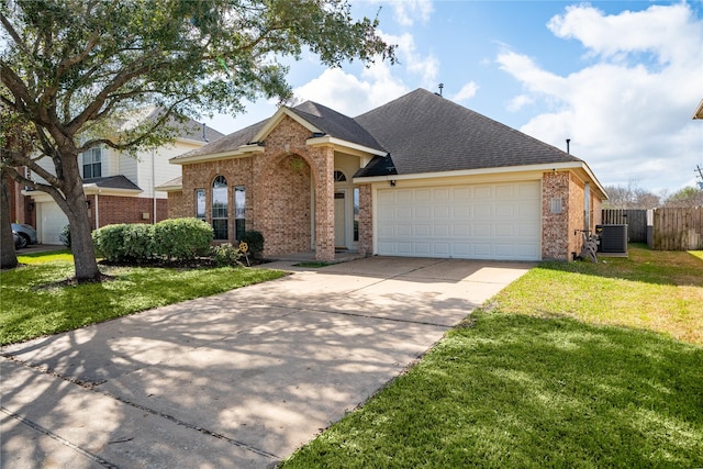 view of front of home with fence, driveway, a front lawn, a garage, and brick siding