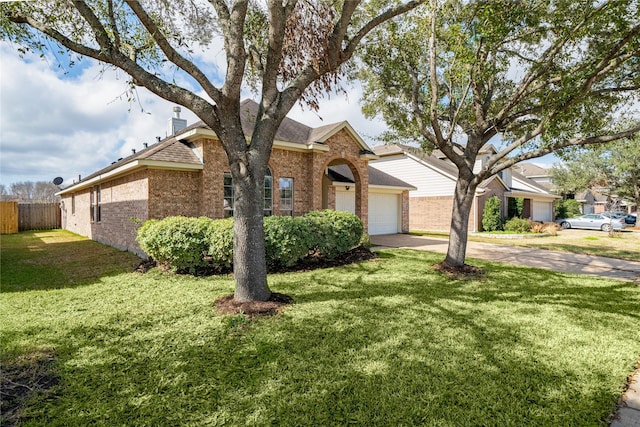 view of front of house featuring a front yard, fence, driveway, a chimney, and brick siding