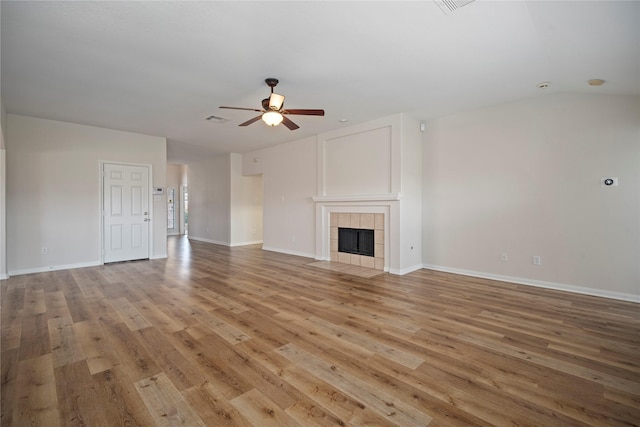 unfurnished living room with visible vents, baseboards, light wood-style flooring, a fireplace, and a ceiling fan