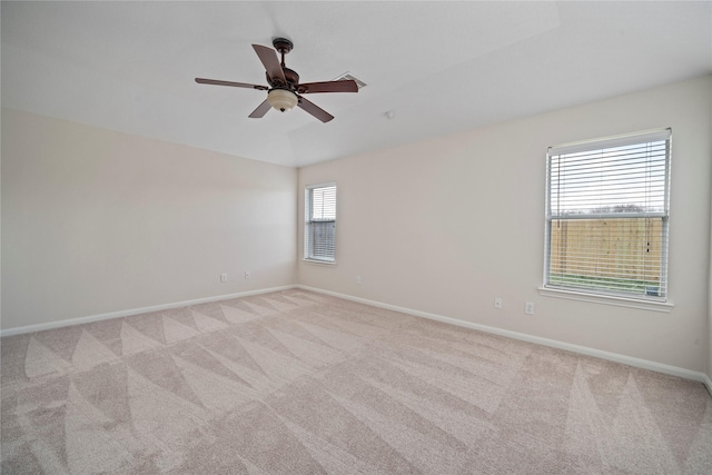 unfurnished room featuring baseboards, light colored carpet, and a ceiling fan