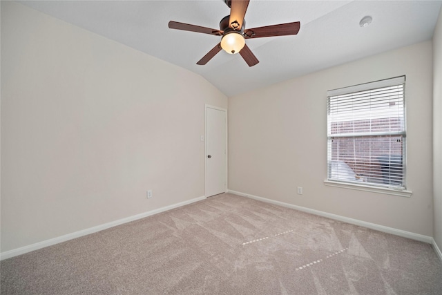 unfurnished room featuring baseboards, light carpet, lofted ceiling, and a ceiling fan