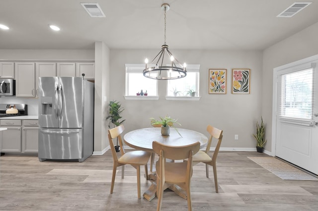 dining area featuring visible vents, a healthy amount of sunlight, and baseboards