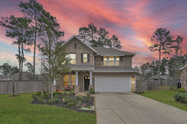 traditional-style house featuring a garage, driveway, a yard, and fence