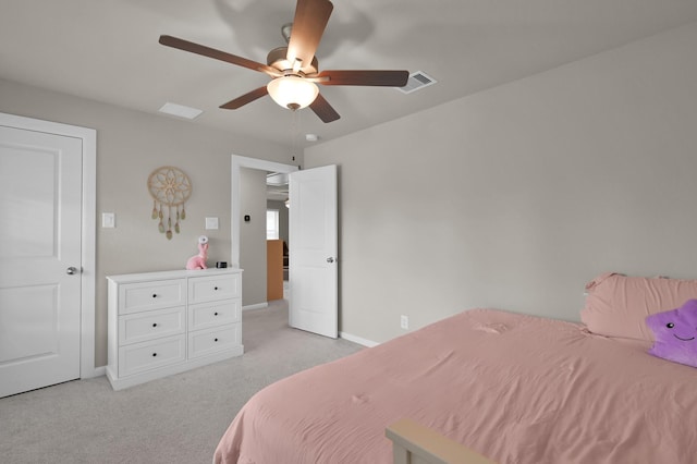 bedroom featuring visible vents, light colored carpet, a ceiling fan, and baseboards