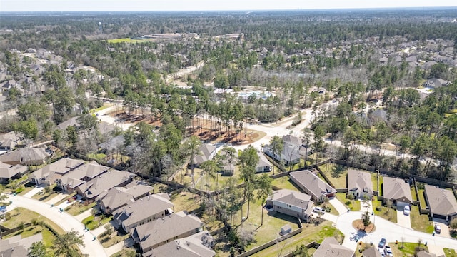 birds eye view of property featuring a wooded view and a residential view