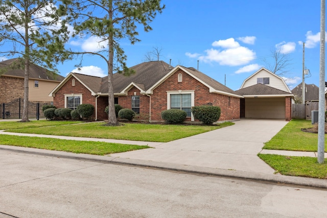 ranch-style house featuring a front yard, concrete driveway, fence, and brick siding