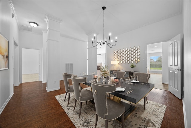 dining space featuring visible vents, baseboards, a notable chandelier, and wood finished floors