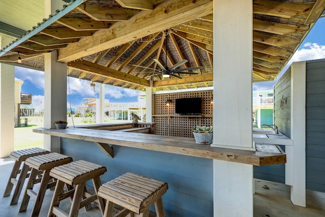 view of patio with a gazebo, a ceiling fan, and outdoor dry bar