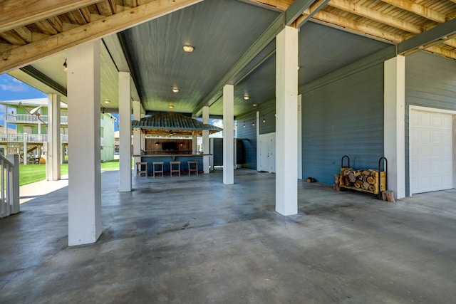 view of patio with outdoor dry bar and a garage