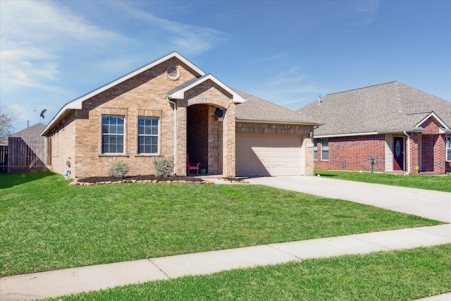 ranch-style house featuring brick siding, a garage, driveway, and a front yard