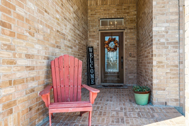 property entrance featuring brick siding