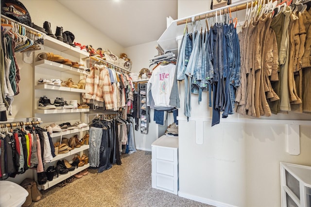 walk in closet with carpet flooring