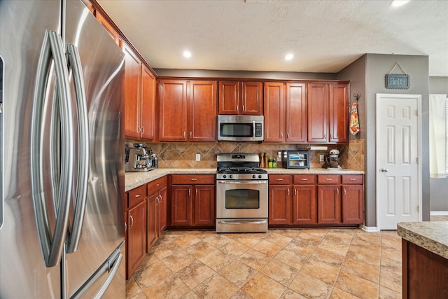 kitchen featuring recessed lighting, backsplash, and appliances with stainless steel finishes