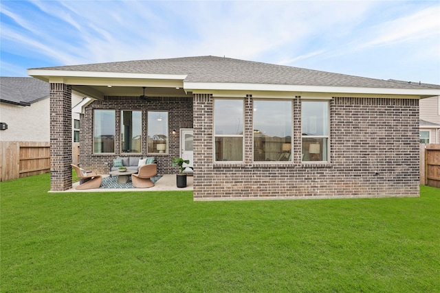 back of house with a yard, brick siding, outdoor lounge area, and fence