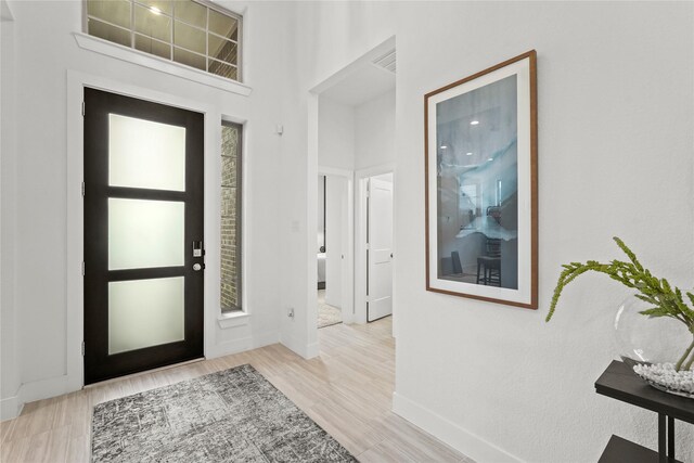 entryway featuring wood finished floors and baseboards