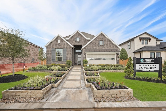 view of front of home with brick siding, a garage, and a front lawn