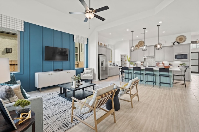 living area featuring recessed lighting and ceiling fan