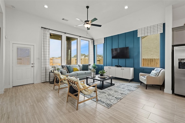 living room featuring recessed lighting, visible vents, lofted ceiling, and ceiling fan