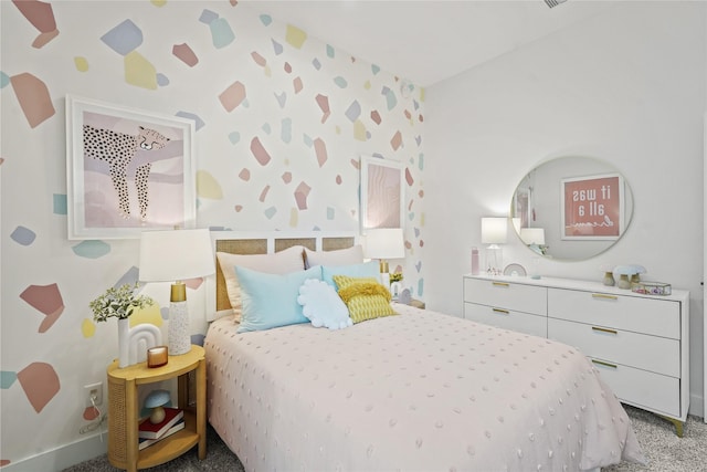 bedroom with light colored carpet and wallpapered walls