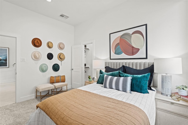 carpeted bedroom with visible vents and baseboards