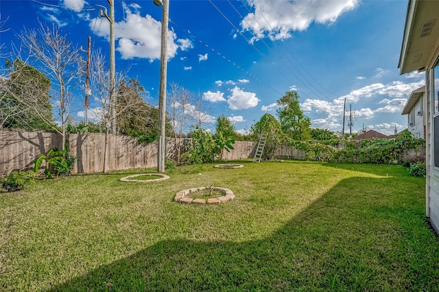 view of yard featuring a fenced backyard and an outdoor fire pit