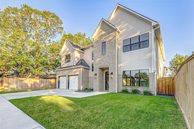 view of front of property with a front yard, fence, an attached garage, concrete driveway, and brick siding