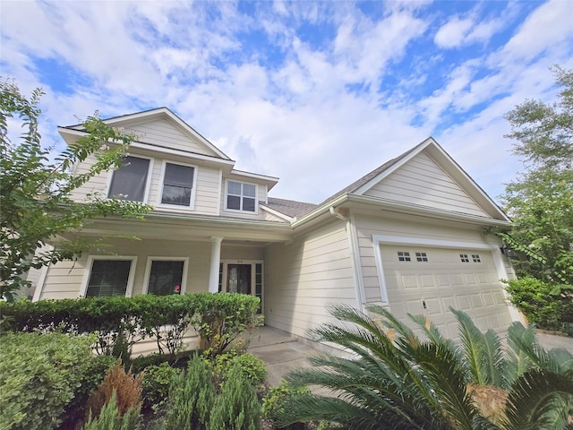 view of front of home featuring an attached garage and covered porch