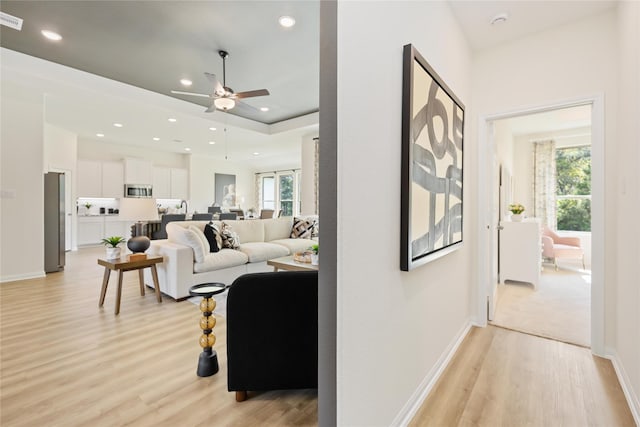 living area featuring light wood-style flooring, plenty of natural light, recessed lighting, and visible vents