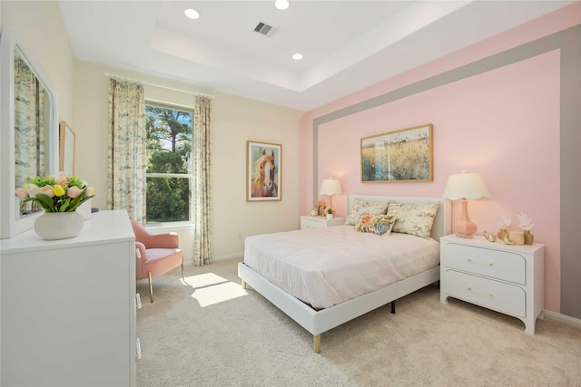 bedroom with visible vents, baseboards, a tray ceiling, recessed lighting, and light colored carpet