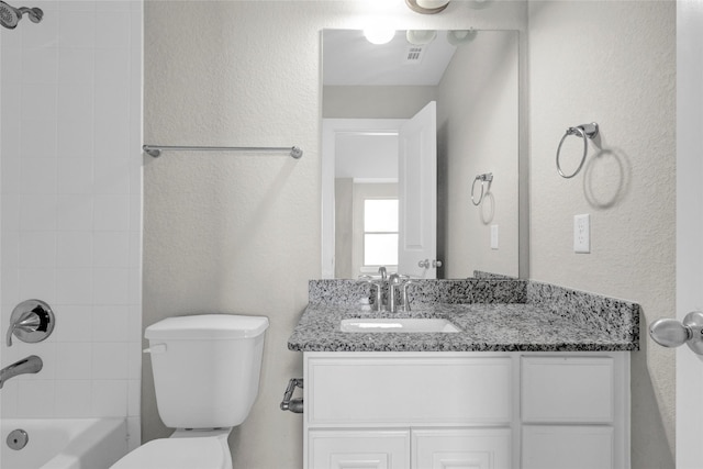 full bathroom featuring visible vents, toilet, vanity, and a textured wall