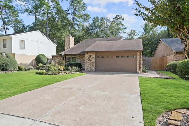 3130 Glade Springs Dr, Houston, TX 77339 - view of front of home with a front lawn, concrete driveway, an attached garage, brick siding, and a chimney