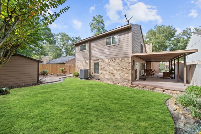 3130 Glade Springs Dr, Houston, TX 77339 - rear view of house with a patio, a fenced backyard, an outdoor structure, a lawn, and brick siding